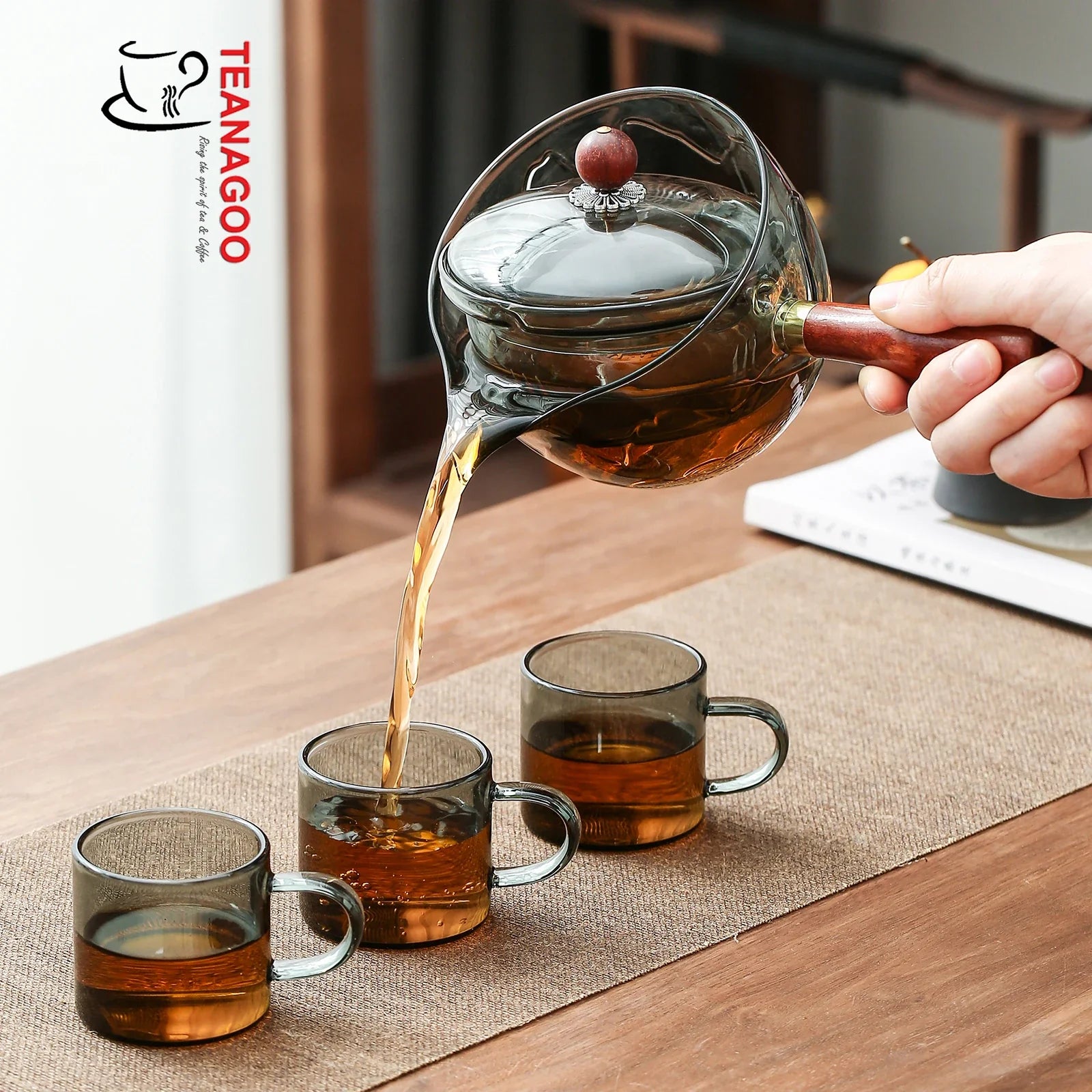 https://www.teanagoo.com/cdn/shop/products/Gray_Glass_Teapot_with_Infuser_and_Rosewood_Handle_275ml_Safe_on_Stove_for_Blooming_and_Loose_Leaf_Tea_Maker_-2.webp?v=1676864808&width=1946